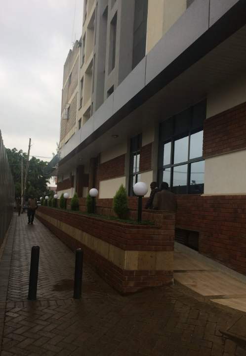 The walkway entrance along Kikinga House with garden lamps and brick planters
